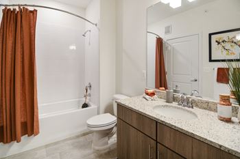 a bathroom with a toilet sink and shower